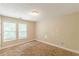 Bedroom featuring two windows and neutral-toned walls at 4671 W Lake Se Dr, Conyers, GA 30094