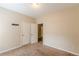 A well-lit bedroom with carpet and a double-door closet at 4671 W Lake Se Dr, Conyers, GA 30094