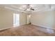 Spacious bedroom featuring a tray ceiling with fan and two entry doors at 4671 W Lake Se Dr, Conyers, GA 30094