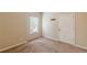 The bedroom offers carpet floors, a window with natural light and a white door at 4671 W Lake Se Dr, Conyers, GA 30094