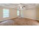 Bedroom with tray ceilings, carpeted floors, and plenty of natural light at 4671 W Lake Se Dr, Conyers, GA 30094