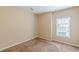 This bedroom features neutral walls, carpet flooring, and a window that provides natural light at 4671 W Lake Se Dr, Conyers, GA 30094