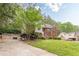 Side view of charming two-story brick home with lush greenery at 4671 W Lake Se Dr, Conyers, GA 30094