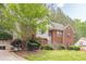 Side view of charming two-story brick home with lush greenery at 4671 W Lake Se Dr, Conyers, GA 30094
