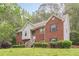 Charming two-story brick home with manicured lawn and inviting entrance at 4671 W Lake Se Dr, Conyers, GA 30094