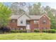 Charming two-story brick home with manicured lawn and inviting entrance at 4671 W Lake Se Dr, Conyers, GA 30094