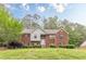 Charming two-story brick home with manicured lawn and inviting entrance at 4671 W Lake Se Dr, Conyers, GA 30094