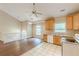 Eat-in kitchen features hardwood floors, tile, wood cabinets and views of upstairs living area at 4671 W Lake Se Dr, Conyers, GA 30094