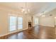 Bright living room features fireplace, hardwood floors, a ceiling fan and access to outside at 4671 W Lake Se Dr, Conyers, GA 30094