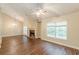 Cozy living room with a brick fireplace, hardwood floors, and lots of natural light at 4671 W Lake Se Dr, Conyers, GA 30094