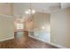 Open concept living room features vaulted ceiling, hardwood floors and a staircase to the upper level at 4671 W Lake Se Dr, Conyers, GA 30094