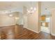 Open-concept living room with hardwood floors, vaulted ceiling, ceiling fan and access to kitchen at 4671 W Lake Se Dr, Conyers, GA 30094