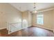 Upstairs bonus living area features hardwood floors, a window and a stairway at 4671 W Lake Se Dr, Conyers, GA 30094