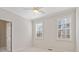 Bright bedroom with neutral walls, carpet flooring, and two windows at 502 Watermill Way, Suwanee, GA 30024