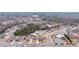 Aerial view of a neighborhood featuring well-maintained homes, green spaces, and a community pool at 7710 Tiberon Pkwy, Cumming, GA 30028