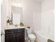 Clean bathroom with dark wood vanity, a toilet, and a tub/shower combination at 7710 Tiberon Pkwy, Cumming, GA 30028