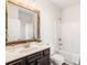 Bathroom featuring vanity with wood frame mirror, white tile, toilet and tub at 7710 Tiberon Pkwy, Cumming, GA 30028