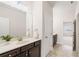 Bathroom sink and vanity with stylish lighting, a framed mirror and tile flooring at 7710 Tiberon Pkwy, Cumming, GA 30028