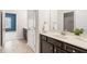 Bathroom featuring a large mirror, quartz countertop, and dark wood cabinets at 7710 Tiberon Pkwy, Cumming, GA 30028