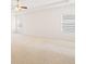 Spacious bedroom with neutral carpet, tray ceiling with fan, and large windows with natural light at 7710 Tiberon Pkwy, Cumming, GA 30028