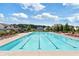 Community pool with lounge chairs surrounded by well-maintained landscaping at 7710 Tiberon Pkwy, Cumming, GA 30028