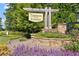 Beautiful stone-framed community sign for Tiberon on the Etowah surrounded by flowers and trees at 7710 Tiberon Pkwy, Cumming, GA 30028