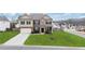 Charming two-story home with brick and stone exterior, manicured lawn, and attached two-car garage at 7710 Tiberon Pkwy, Cumming, GA 30028