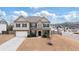 Charming two-story home with brick and stone exterior, manicured lawn, and attached two-car garage at 7710 Tiberon Pkwy, Cumming, GA 30028