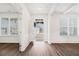 Bright foyer featuring hardwood floors, white trim, and an open view into the living spaces at 7710 Tiberon Pkwy, Cumming, GA 30028