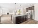 Open kitchen with a granite island, stainless steel appliances and views into the living room at 7710 Tiberon Pkwy, Cumming, GA 30028