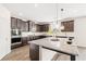 Bright kitchen features dark cabinets, granite countertops, subway tile backsplash, and stainless steel appliances at 7710 Tiberon Pkwy, Cumming, GA 30028