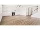 Bright and open living room features a fireplace, built-in shelves, wood-style floors and natural light at 7710 Tiberon Pkwy, Cumming, GA 30028