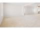 Bright living room featuring neutral walls, carpet flooring, a ceiling fan, and a partial view of the bathroom at 7710 Tiberon Pkwy, Cumming, GA 30028