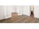 Open-concept living space showcasing hardwood floors, French doors, and lots of natural light at 7710 Tiberon Pkwy, Cumming, GA 30028
