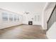 Open-concept living room featuring wood-style floors, natural light, a fireplace, and built-in shelving at 7710 Tiberon Pkwy, Cumming, GA 30028