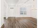 Spacious living room features hardwood floors, white trim, and lots of natural light at 7710 Tiberon Pkwy, Cumming, GA 30028