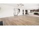Expansive living area flowing into a modern kitchen, featuring hardwood floors, a staircase, and ample space at 7710 Tiberon Pkwy, Cumming, GA 30028