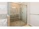 Shower in bathroom has glass door and tile surround at 7710 Tiberon Pkwy, Cumming, GA 30028