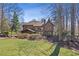 Large backyard with lush grass, mature trees and a patio at 96 Grand Ave, Suwanee, GA 30024
