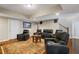 Cozy basement with wood floors, comfy seating and a decorative rug at 96 Grand Ave, Suwanee, GA 30024