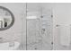 Modern glass shower has marble walls and mosaic tile back at 96 Grand Ave, Suwanee, GA 30024