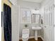 Bright bathroom with pedestal sink, new toilet and stall shower at 96 Grand Ave, Suwanee, GA 30024