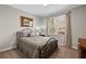 Cozy bedroom featuring neutral paint colors, a comfortable bed, and a view of the outside at 96 Grand Ave, Suwanee, GA 30024