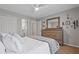 Bedroom offers a ceiling fan, closet, and dresser for storage, adjacent to an en-suite bathroom at 96 Grand Ave, Suwanee, GA 30024