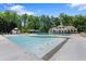 Resort-style community pool with lounge chairs, umbrellas, and a clubhouse in a lush green setting at 96 Grand Ave, Suwanee, GA 30024