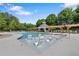 Relaxing community pool with in-water lounge chairs and a covered seating area, perfect for enjoying a sunny day at 96 Grand Ave, Suwanee, GA 30024