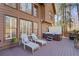 Back deck featuring a private hot tub, lounge chairs, and beautiful views of the surrounding trees at 96 Grand Ave, Suwanee, GA 30024