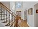 Grand foyer with hardwood floors, a staircase with iron railings, and a large window providing natural light at 96 Grand Ave, Suwanee, GA 30024