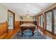 Expansive game room boasting a pool table, bar area, and access to the outdoors at 96 Grand Ave, Suwanee, GA 30024