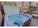 Inviting hot tub on a wood deck with views of the trees; perfect for relaxation and enjoying the natural surroundings at 96 Grand Ave, Suwanee, GA 30024